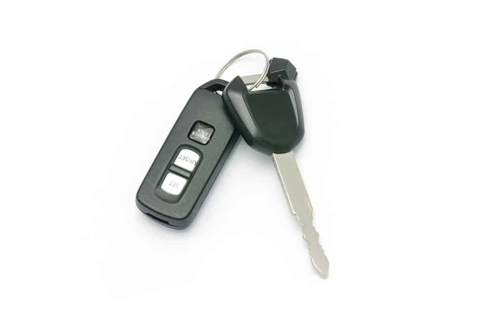 Motorbike Key And Remote On White Background — All Pro Locksmiths in Port Macquarie, NSW